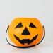 Bright orange pumpkin bucket for Halloween, perfect for trick-or-treat candy collection.